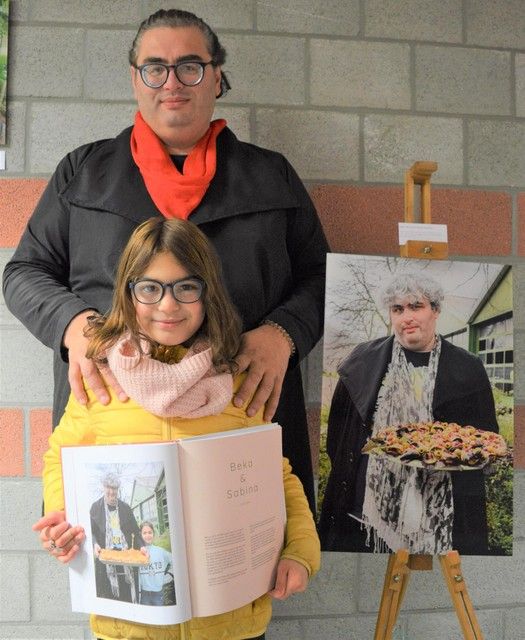 Beka and Sabina with the book and the photo from the photo exhibition.